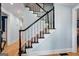 Classic staircase with white spindles, a black handrail, and carpeted steps leading to the upper level at 171 Ponderosa Drive, Fayetteville, GA 30214