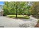Circular driveway leads to home featuring lush green lawn and wooded backdrop at 171 Ponderosa Drive, Fayetteville, GA 30214