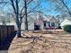 Spacious backyard featuring an inviting patio set, mature trees, and lush greenery, perfect for outdoor entertaining at 486 Village Cir, Stockbridge, GA 30281