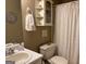 Cozy bathroom with white fixtures, and an overhead cabinet for ample storage at 486 Village Cir, Stockbridge, GA 30281