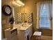 Well-lit bathroom featuring a vanity with a sink, white cabinets, and a window at 486 Village Cir, Stockbridge, GA 30281