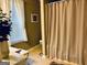 Bathroom featuring a vanity, a window with white curtains, and a shower with a textured curtain at 486 Village Cir, Stockbridge, GA 30281