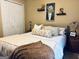 Bedroom featuring a cozy bed, white bedding, and decorative elements on shelves above the bed at 486 Village Cir, Stockbridge, GA 30281