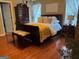 Comfortable bedroom featuring a bed, dresser, and hardwood floors at 486 Village Cir, Stockbridge, GA 30281