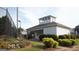 Exterior shot of the clubhouse, landscaping, and adjacent tennis court at 486 Village Cir, Stockbridge, GA 30281