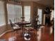 Sunlit dining area features hardwood floors, seating for four, and view of backyard at 486 Village Cir, Stockbridge, GA 30281