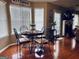 Cozy dining area featuring a round table with seating for four and natural light from large windows at 486 Village Cir, Stockbridge, GA 30281