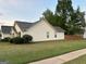 Exterior side view of a one-story home with a well-manicured lawn at 486 Village Cir, Stockbridge, GA 30281