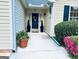 Inviting front entrance with potted plants and a stylish wreath on the door at 486 Village Cir, Stockbridge, GA 30281