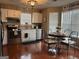Bright kitchen featuring white cabinets, stainless steel appliances, and a cozy breakfast nook at 486 Village Cir, Stockbridge, GA 30281