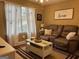 Living room features a comfortable brown couch, bright natural light, and a decorative coffee table at 486 Village Cir, Stockbridge, GA 30281