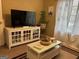 Living room offers bright natural light, decorative furniture, and a sleek entertainment center at 486 Village Cir, Stockbridge, GA 30281