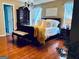 Spacious main bedroom featuring a large bed, hardwood floors, and ample natural light at 486 Village Cir, Stockbridge, GA 30281
