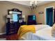 Main bedroom with a dark wood dresser, soft lighting, and a comfortable bed with a yellow throw at 486 Village Cir, Stockbridge, GA 30281