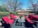 Relaxing patio with comfortable outdoor seating and a small table, surrounded by a yard and landscaping at 486 Village Cir, Stockbridge, GA 30281