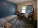 Bedroom featuring carpet, blue walls, and two windows at 1071 Ponderosa Park Dr, Forest Park, GA 30297