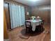 Dining room featuring wood-paneled walls and hardwood floors at 1071 Ponderosa Park Dr, Forest Park, GA 30297