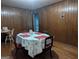 Cozy dining room featuring hardwood floors, wood paneled walls and a vintage table at 1071 Ponderosa Park Dr, Forest Park, GA 30297