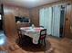 Dining room featuring wood-paneled walls and hardwood floors at 1071 Ponderosa Park Dr, Forest Park, GA 30297