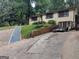 Charming brick home with a long driveway, lush green grass and mature trees at 1071 Ponderosa Park Dr, Forest Park, GA 30297