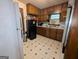 Kitchen featuring wood cabinets, white countertops, and tile floors with a black refrigerator at 1071 Ponderosa Park Dr, Forest Park, GA 30297