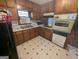 Kitchen featuring wood cabinets, white countertops, and tile floors at 1071 Ponderosa Park Dr, Forest Park, GA 30297
