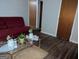 Inviting living room with comfortable red sofa and hardwood flooring at 1071 Ponderosa Park Dr, Forest Park, GA 30297