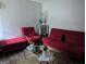 Bright living room featuring red furniture, modern decorations and hardwood floors at 1071 Ponderosa Park Dr, Forest Park, GA 30297