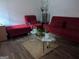 Comfortable living room featuring red furniture and a glass coffee table at 1071 Ponderosa Park Dr, Forest Park, GA 30297