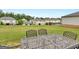 Large backyard features a lush green lawn and patio seating, perfect for entertaining at 168 Warbler Way, Mcdonough, GA 30253