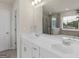 Bright bathroom featuring double sinks, a large mirror, tile floors, and a separate shower and tub at 168 Warbler Way, Mcdonough, GA 30253