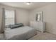 Cozy bedroom with a comfortable bed, dresser, and natural light from the window at 168 Warbler Way, Mcdonough, GA 30253