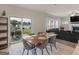 Dining area with patio access, a large wood table, and an open view into the living room with fireplace at 168 Warbler Way, Mcdonough, GA 30253