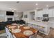 Open-concept dining area with a view of the kitchen, living room, fireplace, and staircase at 168 Warbler Way, Mcdonough, GA 30253
