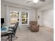Well-lit living room featuring a comfortable chair, neutral carpet, and ample natural light at 168 Warbler Way, Mcdonough, GA 30253