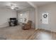 Bright living room with large windows, a cozy chair, and a dedicated workspace at 168 Warbler Way, Mcdonough, GA 30253