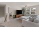 Comfortable living room featuring a large sectional sofa, TV, and views of the neighborhood at 168 Warbler Way, Mcdonough, GA 30253