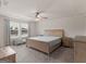 Spacious main bedroom featuring tray ceiling, neutral paint, plush carpet, and bright natural light at 168 Warbler Way, Mcdonough, GA 30253