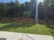 Landscaped backyard with green grass and tree line offers privacy at 6120 Ripple Way # 46, South Fulton, GA 30349