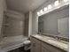 Modern bathroom featuring granite countertops, double sinks, and a shower-tub combination at 6120 Ripple Way # 46, South Fulton, GA 30349