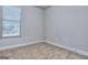 A bedroom with neutral carpet and natural light from the window at 6120 Ripple Way # 46, South Fulton, GA 30349