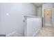 Bright hallway with access to the laundry room and neutral carpeting, enhancing the modern feel of the home at 6120 Ripple Way # 46, South Fulton, GA 30349