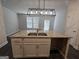 Kitchen island featuring stainless steel sink, granite countertop, white cabinets, and pendant lighting at 6120 Ripple Way # 46, South Fulton, GA 30349