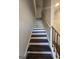 Interior view of staircase featuring stained wood treads and white risers, railing and white walls at 6120 Ripple Way # 46, South Fulton, GA 30349