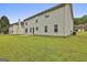 Spacious backyard with lush green grass and exterior home view at 122 Claxton Ct, Jonesboro, GA 30238
