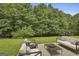 Outdoor patio area featuring modern seating, perfect for relaxing or entertaining guests in a green backyard setting at 122 Claxton Ct, Jonesboro, GA 30238