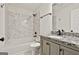 Bathroom featuring granite countertops, soaking tub and shower combo, and neutral tile at 122 Claxton Ct, Jonesboro, GA 30238