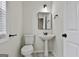 Charming half-bath with pedestal sink, modern fixtures, and tiled floor at 122 Claxton Ct, Jonesboro, GA 30238