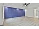 Bedroom featuring a navy accent wall, trey ceiling, and hardwood floors at 122 Claxton Ct, Jonesboro, GA 30238