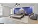 Well-lit bedroom with a navy accent wall, and hardwood floors at 122 Claxton Ct, Jonesboro, GA 30238